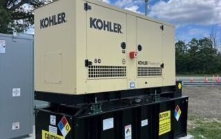 Long Island Power Systems Offers Kohler Industrial Generators Engineered for Steady Business Power | 8 | Long Island Power Systems A beige Kohler generator with “80” and “Kohler PowerSystems” printed on it, sitting on a black metal frame over a concrete pad.