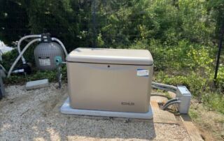 Maintaining Generator Readiness Year-Round: Seasonal Care Tips for Backup Power Generators | 10 | Long Island Power Systems A Kohler generator installed on a concrete pad next to a pool filter system, surrounded by greenery.