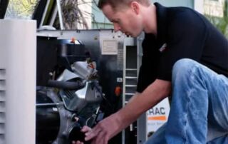 How Power Emergencies Affect Essential Home Systems Beyond Lighting | Emergency Backup Generators | 5 | Long Island Power Systems Technician inspecting and repairing a residential standby generator